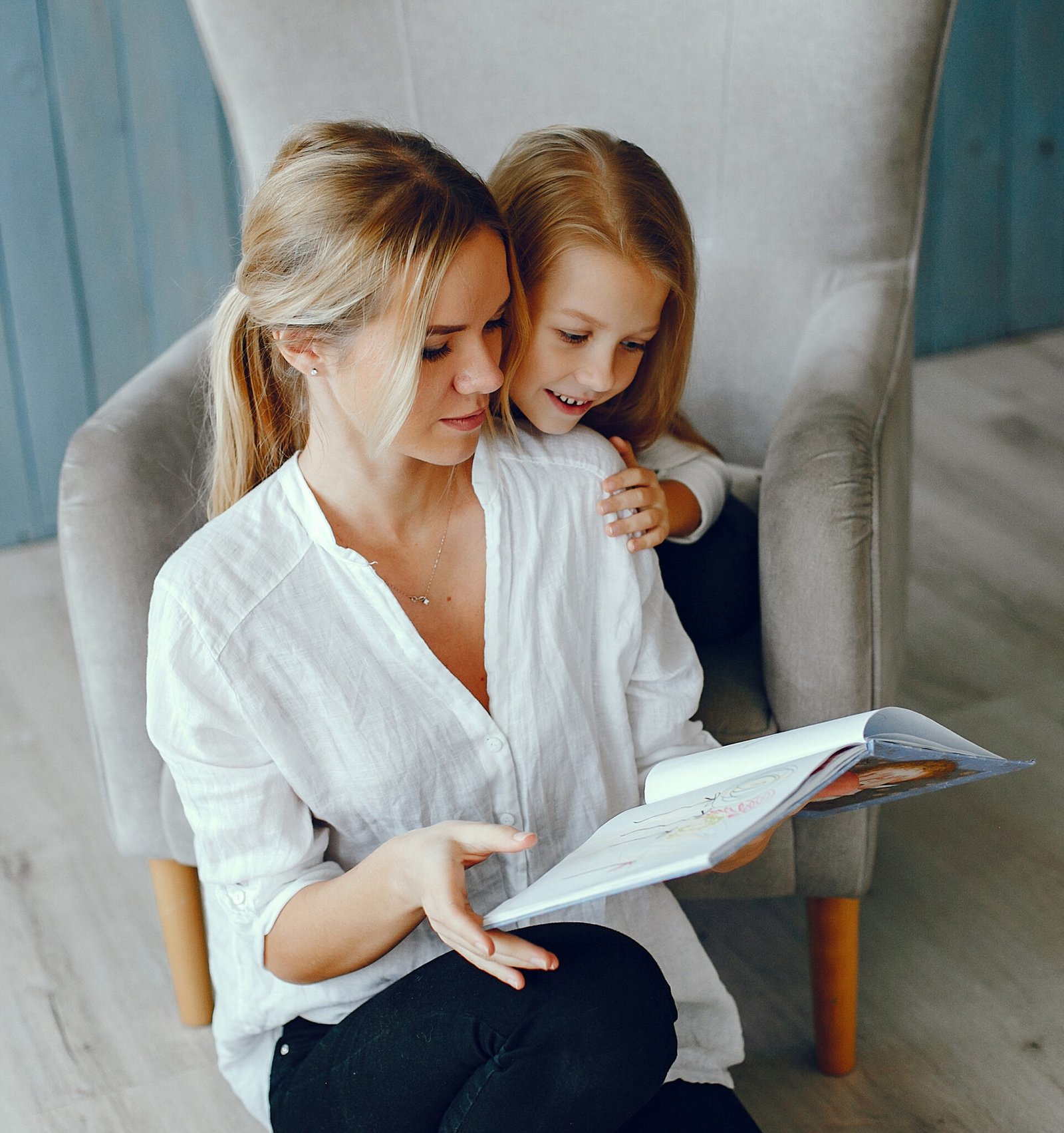 mother reading a book with daughter